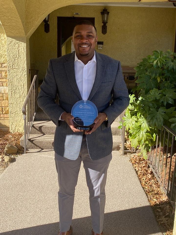 Councilman Smith holding glass plaque for years of service